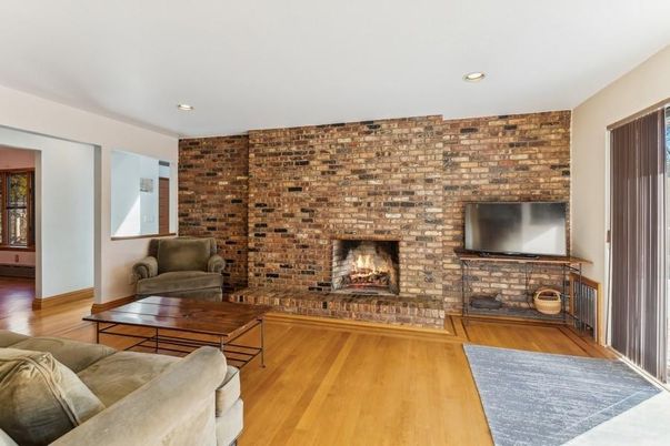 Fireplace, Interior, Living room, Recessed Lighting, Stone Walls, Wood Texture Flooring