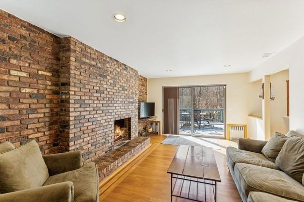 Fireplace, Interior, Living room, Recessed Lighting, Stone Walls, Wood Texture Flooring
