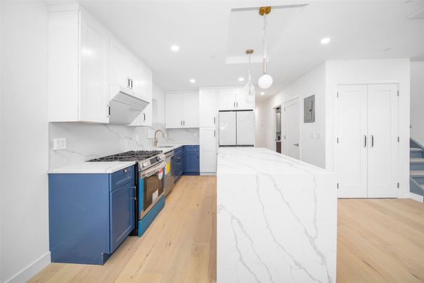 Interior, Kitchen, Marble Walls, Pendant Lights, Recessed Lighting, Stainless Steel Appliances, Wood Texture Flooring
