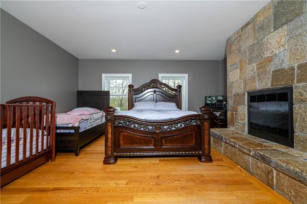 Bedroom, Fireplace, Interior, Recessed Lighting, Stone Walls, Wood Texture Flooring