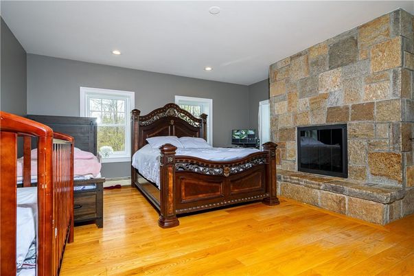 Bedroom, Fireplace, Interior, Recessed Lighting, Stone Walls, Wood Texture Flooring