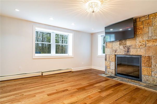 Empty room, Fireplace, Interior, Recessed Lighting, Stone Walls, Wood Texture Flooring