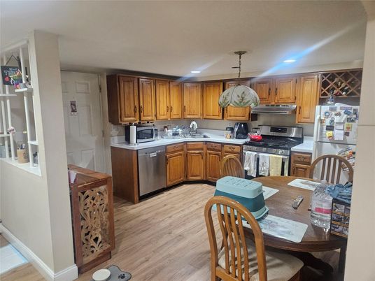 Dining room, Interior, Kitchen, Pendant Lights, Recessed Lighting, Stainless Steel Appliances, Wood Texture Flooring