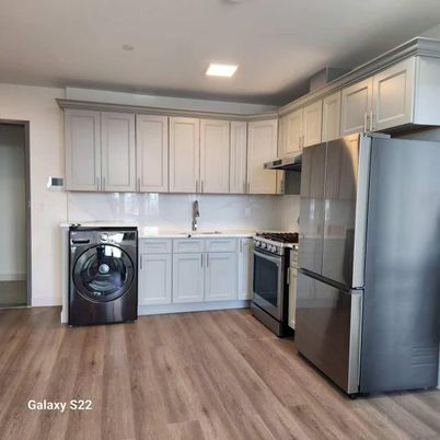 Interior, Kitchen, Recessed Lighting, Washer, Wood Texture Flooring