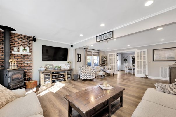Dining room, Fireplace, Interior, Living room, Recessed Lighting, Stone Walls, Wood Texture Flooring