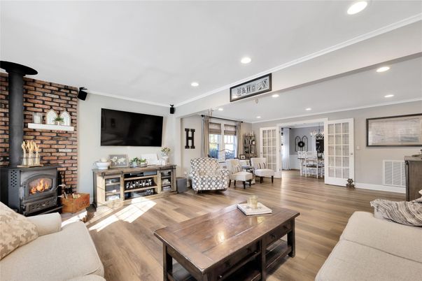 Dining room, Fireplace, Interior, Living room, Recessed Lighting, Stone Walls, Wood Texture Flooring