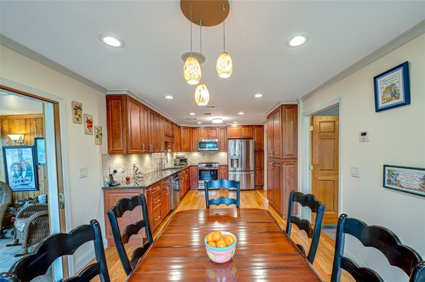 Dining room, Interior, Kitchen, Pendant Lights, Recessed Lighting, Stainless Steel Appliances, Wood Texture Flooring