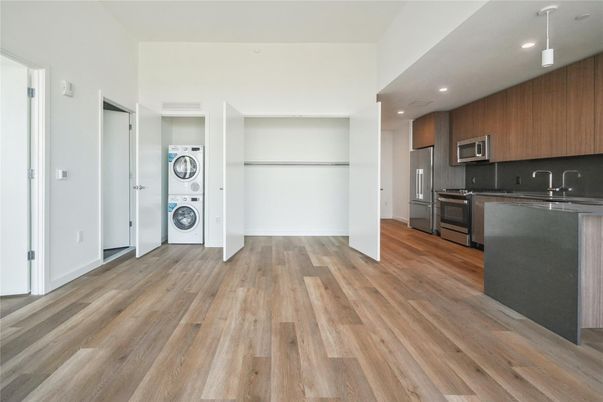 Interior, Kitchen, Recessed Lighting, Washer, Wood Texture Flooring
