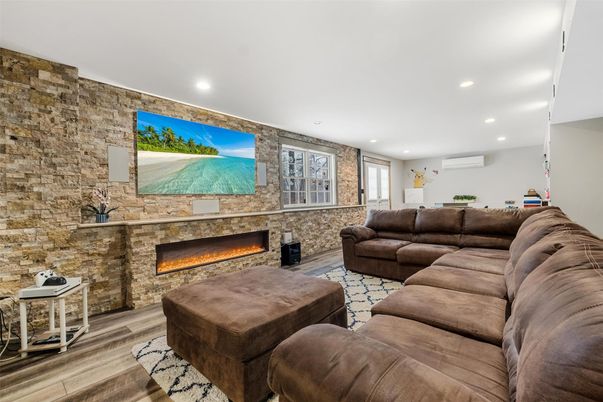 Fireplace, Interior, Living room, Recessed Lighting, Stone Walls, Wood Texture Flooring