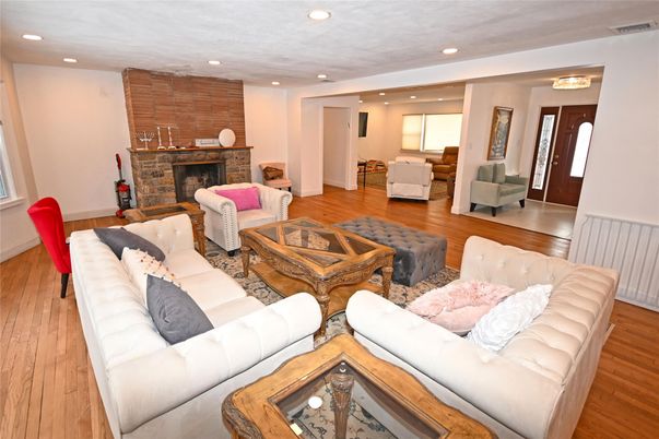 Fireplace, Interior, Living room, Recessed Lighting, Stone Walls, Wood Texture Flooring