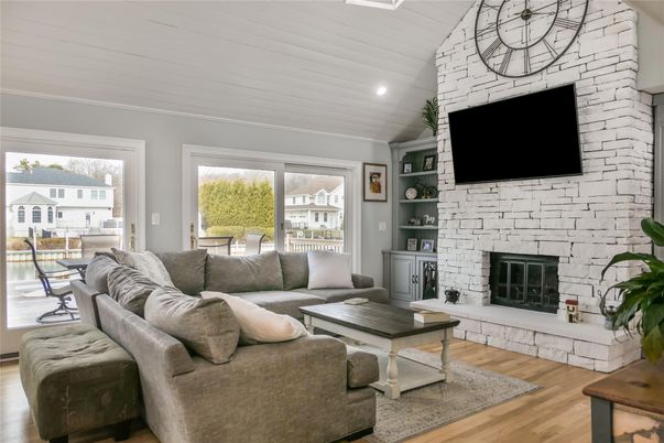 Fireplace, Interior, Living room, Recessed Lighting, Stone Walls, Wood Texture Flooring