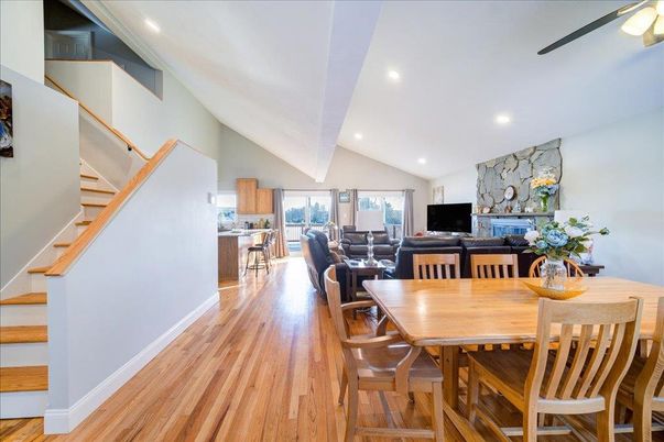 Dining room, Fireplace, Interior, Living room, Recessed Lighting, Stone Walls, Wood Texture Flooring
