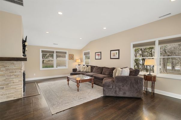 Fireplace, Interior, Living room, Recessed Lighting, Stone Walls, Wood Texture Flooring