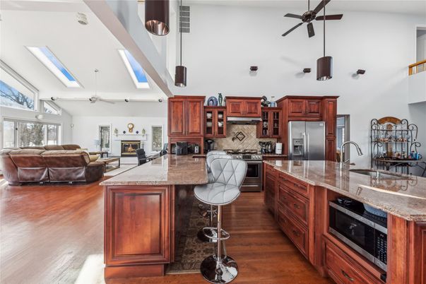 Fireplace, Interior, Kitchen, Living room, Pendant Lights, Stainless Steel Appliances, Wood Texture Flooring