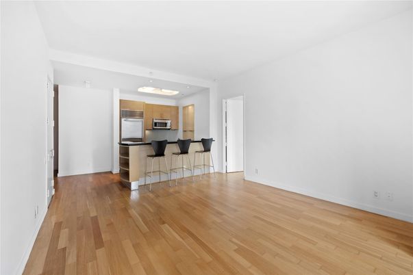 Empty room, Interior, Kitchen, Recessed Lighting, Stainless Steel Appliances, Wood Texture Flooring
