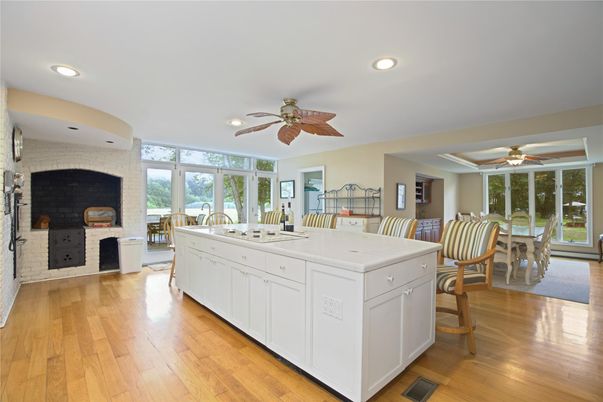 Dining room, Fireplace, Interior, Kitchen, Recessed Lighting, Stone Walls, Wood Texture Flooring