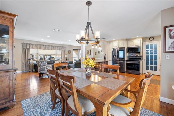 Chandelier, Dining room, Interior, Kitchen, Living room, Pendant Lights, Recessed Lighting, Stainless Steel Appliances, Wood Texture Flooring