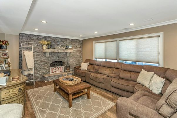 Fireplace, Interior, Living room, Recessed Lighting, Stone Walls, Wood Texture Flooring