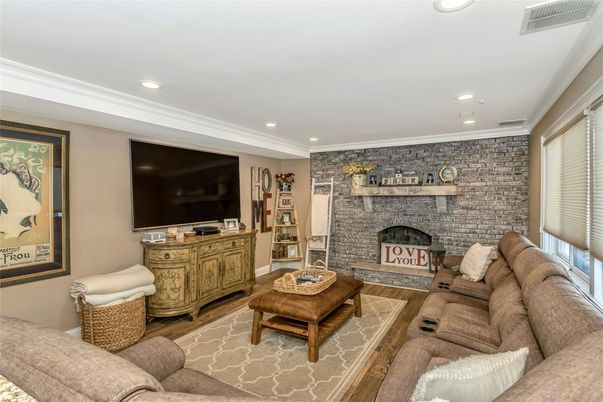 Fireplace, Interior, Living room, Recessed Lighting, Stone Walls, Wood Texture Flooring