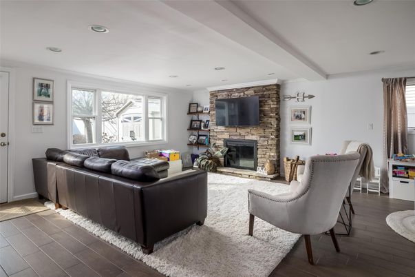 Fireplace, Interior, Living room, Recessed Lighting, Stone Walls, Wood Texture Flooring