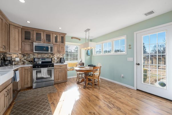 Chandelier, Dining room, Interior, Kitchen, Pendant Lights, Recessed Lighting, Stainless Steel Appliances, Wood Texture Flooring