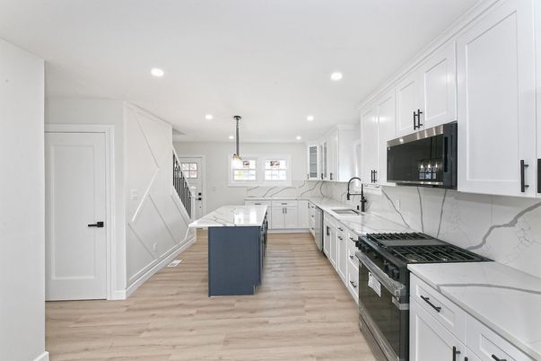 Interior, Kitchen, Marble Walls, Pendant Lights, Recessed Lighting, Stainless Steel Appliances, Wood Texture Flooring