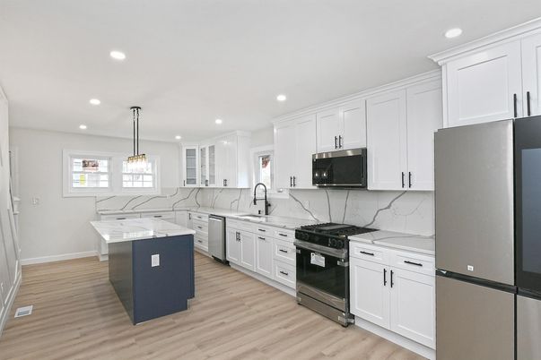 Interior, Kitchen, Marble Walls, Pendant Lights, Recessed Lighting, Stainless Steel Appliances, Wood Texture Flooring