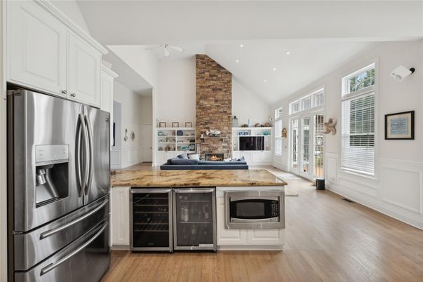 Fireplace, Interior, Kitchen, Recessed Lighting, Stainless Steel Appliances, Stone Walls, Wood Texture Flooring