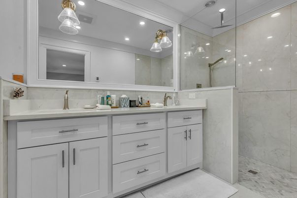 Bathroom, Dual Sink Vanities, Glass Shower, Interior, Marble, Marble Walls, Pendant Lights, Recessed Lighting