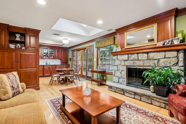 Dining room, Fireplace, Interior, Living room, Recessed Lighting, Stone Walls, Wood Texture Flooring