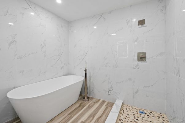 Bathroom, Free Standing Baths, Glass Shower, Interior, Marble Walls, Recessed Lighting, Wood Texture Flooring