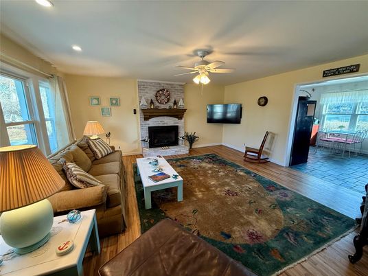 Fireplace, Interior, Living room, Recessed Lighting, Stone Walls, Wood Texture Flooring