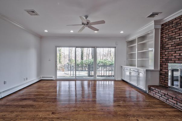 Empty room, Fireplace, Interior, Recessed Lighting, Stone Walls, Wood Texture Flooring