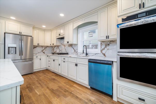 Interior, Kitchen, Marble Walls, Recessed Lighting, Stainless Steel Appliances, Wood Texture Flooring