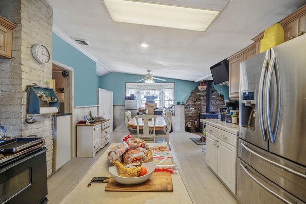 Dining room, Interior, Kitchen, Recessed Lighting, Stainless Steel Appliances, Stone Walls, Wood Texture Flooring