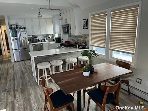 Dining room, Interior, Kitchen, Pendant Lights, Recessed Lighting, Stainless Steel Appliances, Wood Texture Flooring