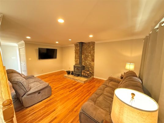 Fireplace, Interior, Living room, Recessed Lighting, Stone Walls, Wood Texture Flooring