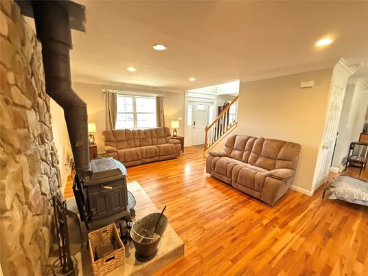 Fireplace, Interior, Living room, Recessed Lighting, Stone Walls, Wood Texture Flooring