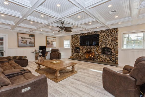 Fireplace, Interior, Living room, Recessed Lighting, Stone Walls, Wood Texture Flooring