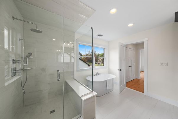 Bathroom, Free Standing Baths, Glass Shower, Interior, Marble Walls, Recessed Lighting, Wood Texture Flooring