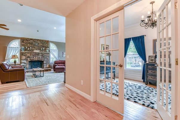 Chandelier, Fireplace, Interior, Living room, Recessed Lighting, Stone Walls, Wood Texture Flooring