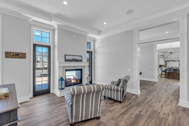 Chandelier, Dining room, Fireplace, Interior, Living room, Pendant Lights, Recessed Lighting, Wood Texture Flooring