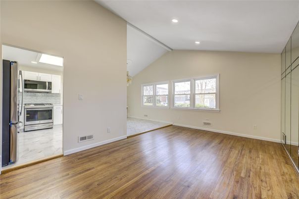 Empty room, Interior, Kitchen, Marble, Recessed Lighting, Stainless Steel Appliances, Wood Texture Flooring