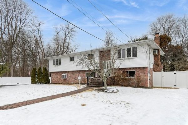Attached, Backyard, Exterior, Facade, Brick Facade, Raised Ranch