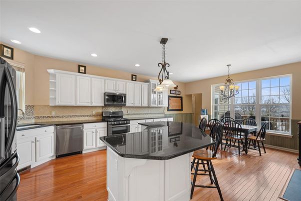 Chandelier, Dining room, Interior, Kitchen, Pendant Lights, Recessed Lighting, Stainless Steel Appliances, Wood Texture Flooring
