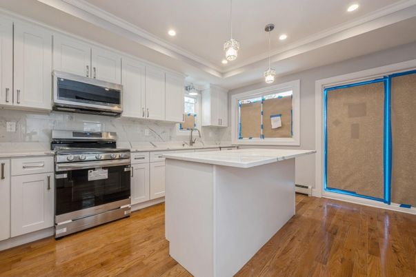 Interior, Kitchen, Marble Walls, Pendant Lights, Recessed Lighting, Stainless Steel Appliances, Wood Texture Flooring