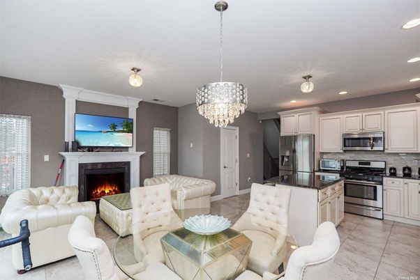 Chandelier, Fireplace, Interior, Kitchen, Living room, Recessed Lighting, Stainless Steel Appliances