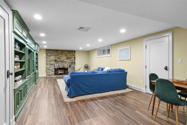Dining room, Fireplace, Interior, Living room, Recessed Lighting, Stone Walls, Wood Texture Flooring