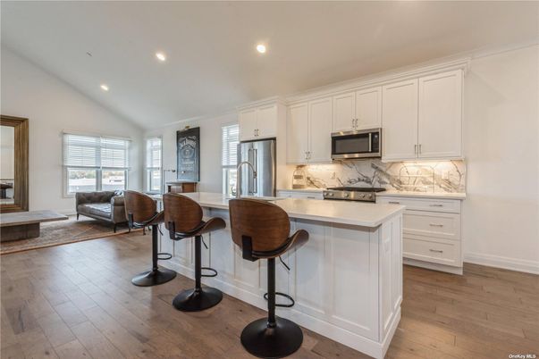 Interior, Kitchen, Marble Walls, Recessed Lighting, Stainless Steel Appliances, Wood Texture Flooring