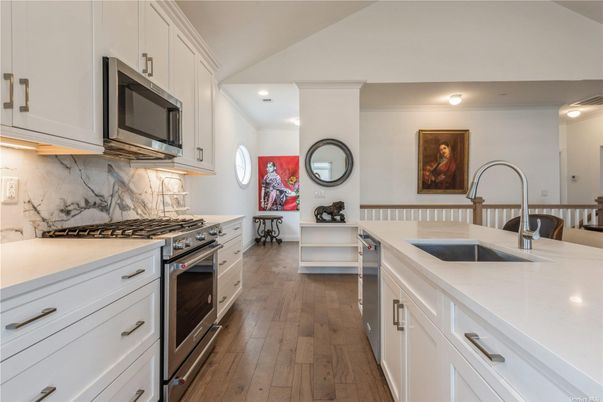 Interior, Kitchen, Marble Walls, Recessed Lighting, Stainless Steel Appliances, Wood Texture Flooring